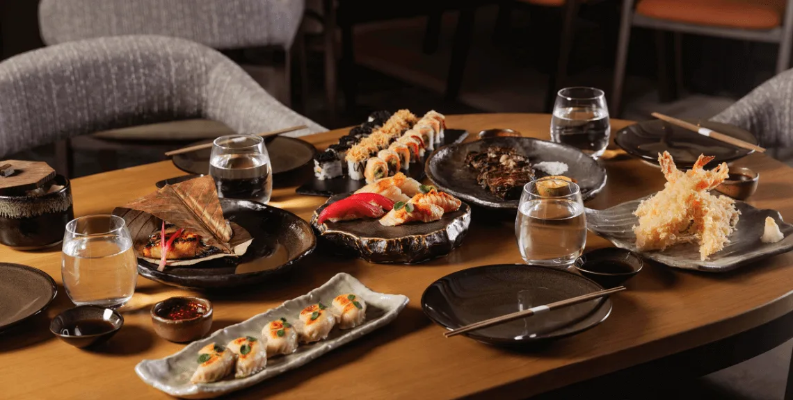 Seafood on a table with people from a side angle